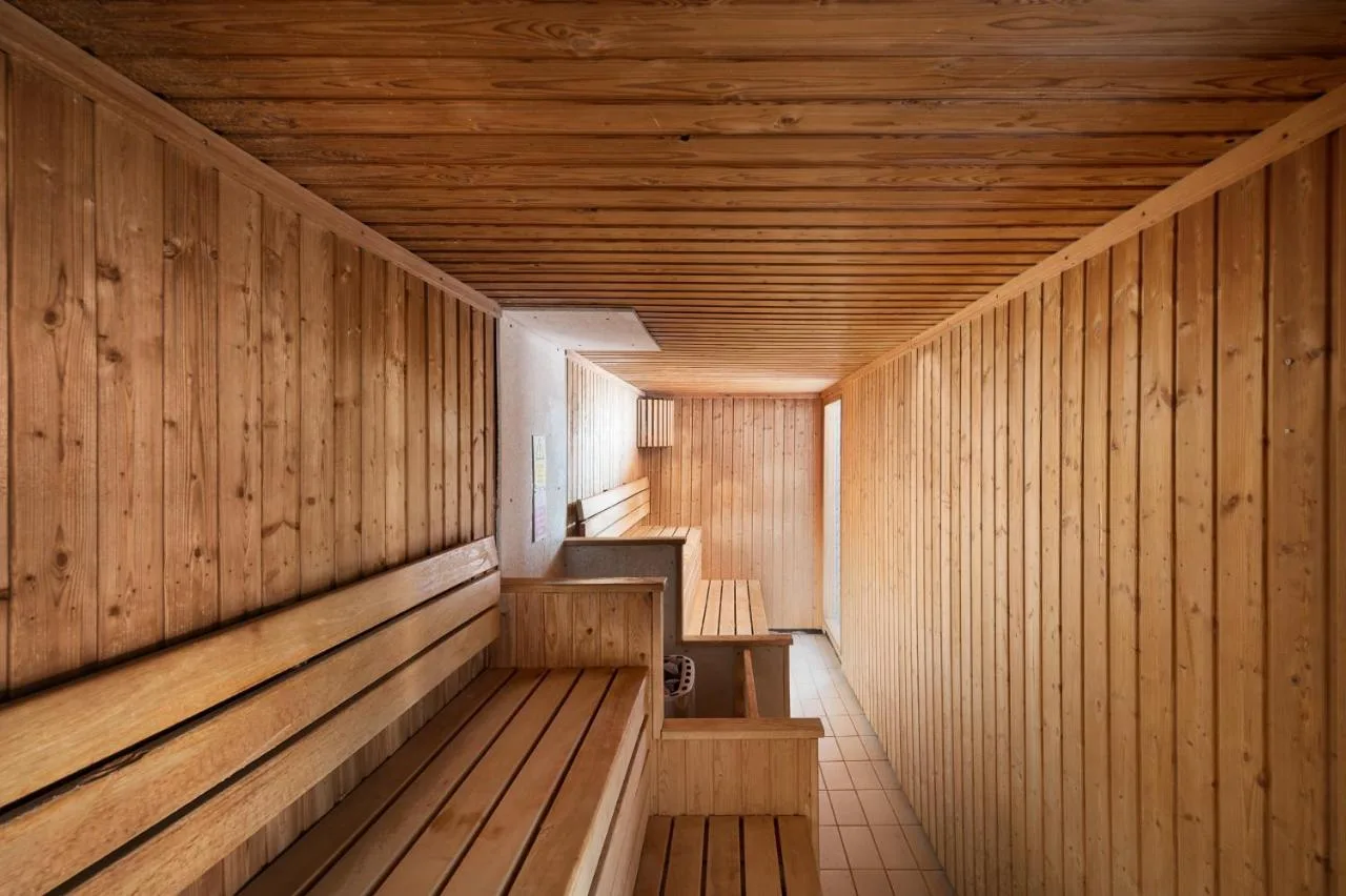 a sauna with wood panelled walls and a wooden ceiling at voco St. David's Cardiff by IHG in Cardiff