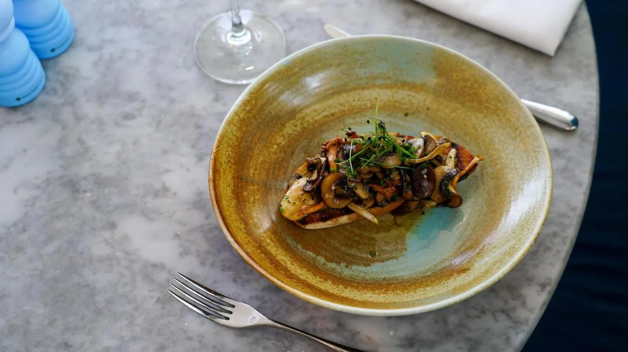 a bowl of food on a table with a fork at voco St. David's Cardiff by IHG in Cardiff